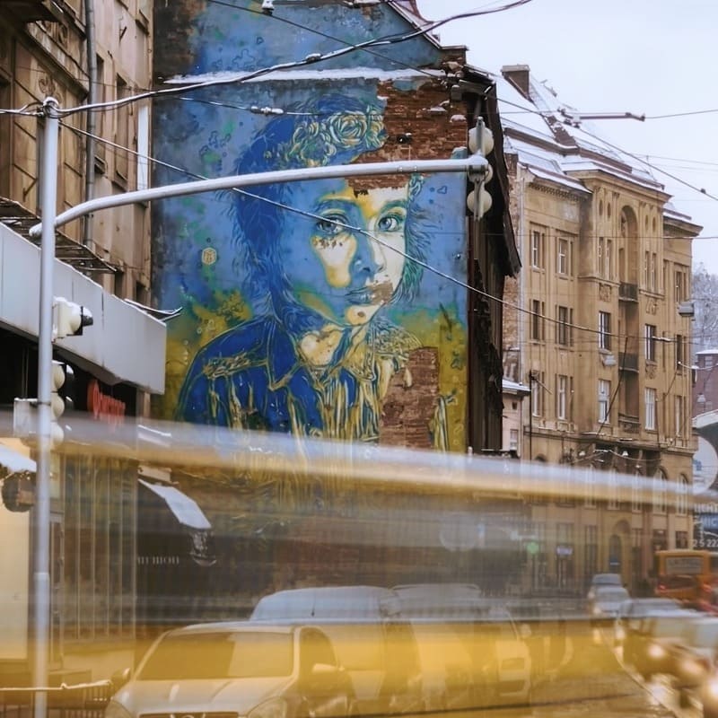 A Mural In Lviv Old Town As A Tram Whooses Past, Lviv, Ukraine