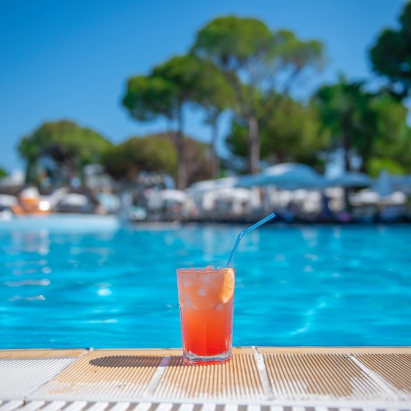 Alcoholic Drink Resting By The Poolside At A Luxury Resort In The Mexican Caribbean, Mexico