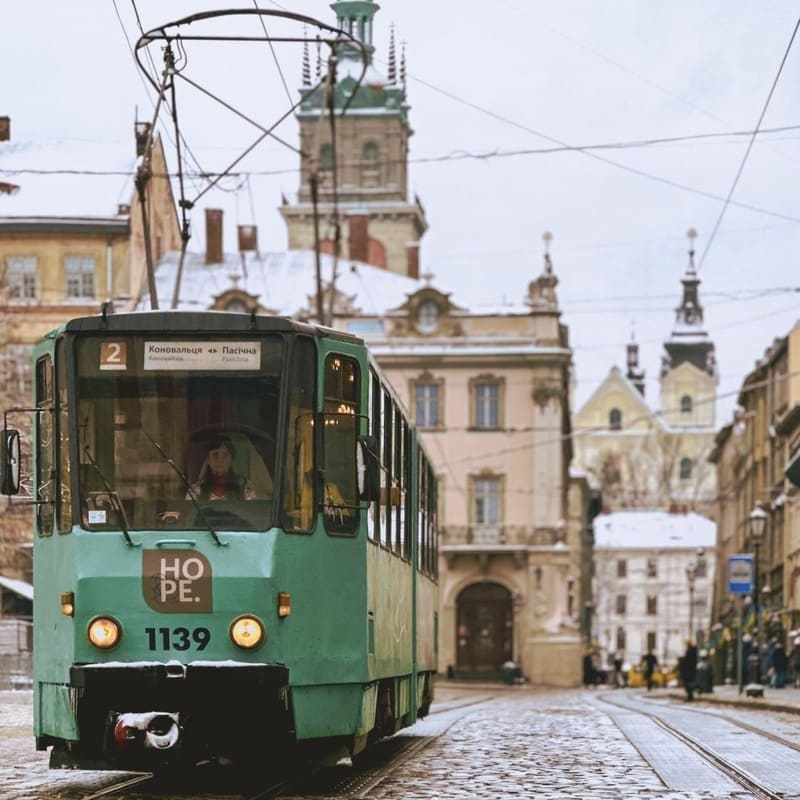 Green Tram Traveling Through Rynok Square In Lviv Old Town, Ukraine