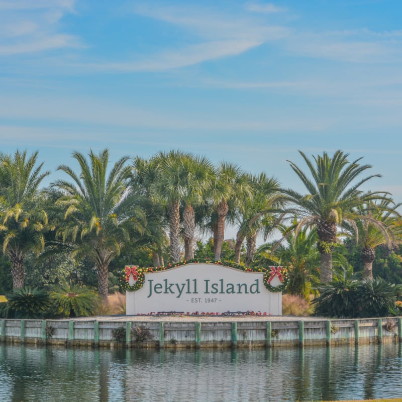 Jekyll Island sign backdropped by palm trees