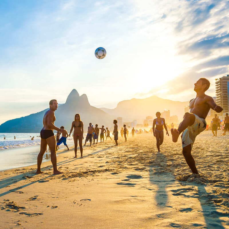 Men Playing Football On A Beach In Rio de Janeiro, Brazil