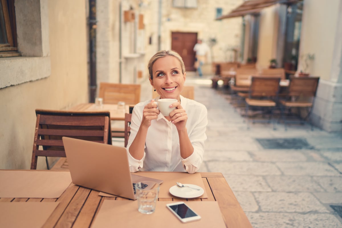 Digital nomad sipping coffee at Italian cafe