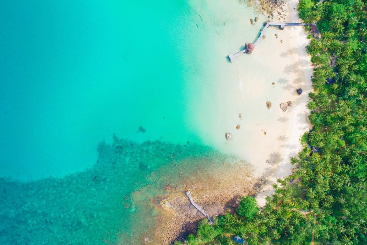 Aerial view of Koh Kood's turquoise waters and lush canopy