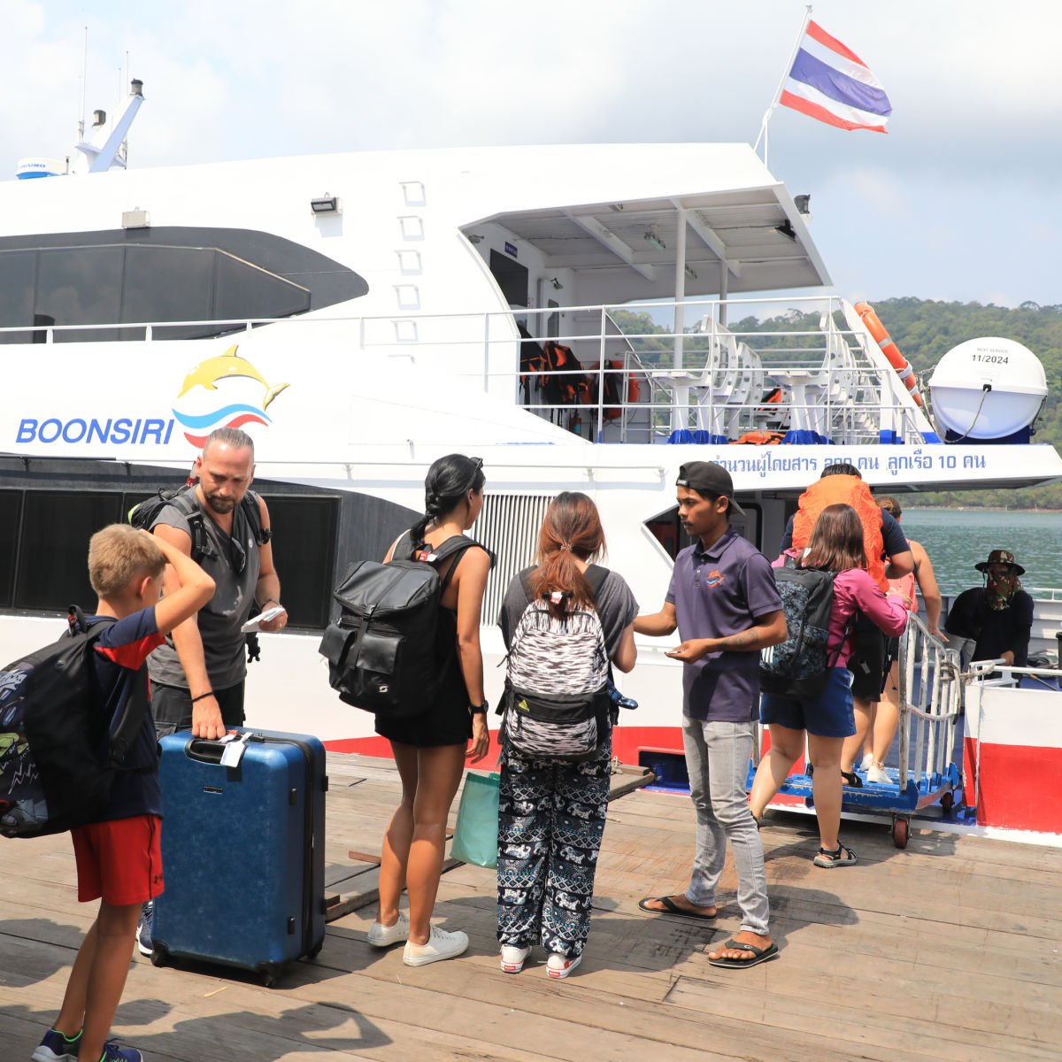 Travelers boarding Boonsiri catamaran