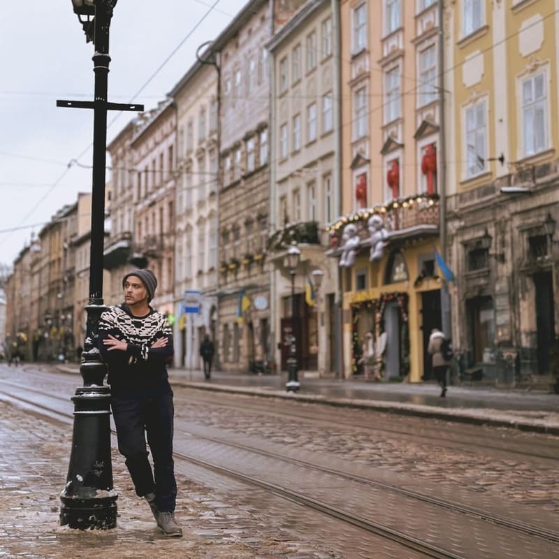 Young Man Posing In Rynok Square By The Tram Tracks, Lviv, Ukraine