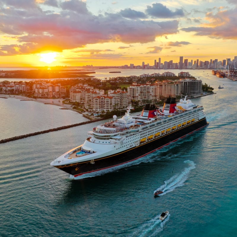 disney cruise ship sailing away from miami florida at sunset