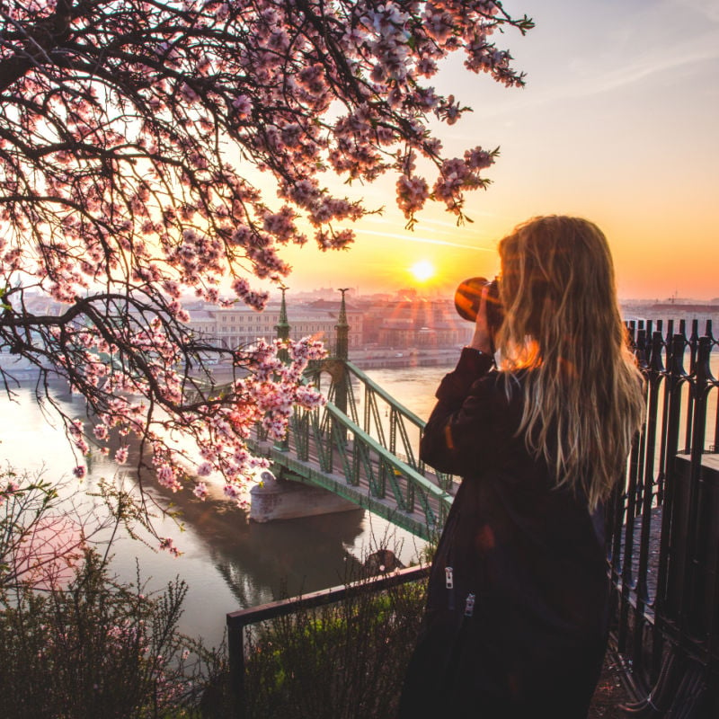 woman taking photo of river danube budapest