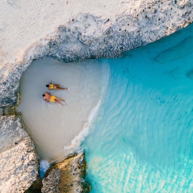 A couple on the beach of Tres Trap Aruba Caribbean Island.