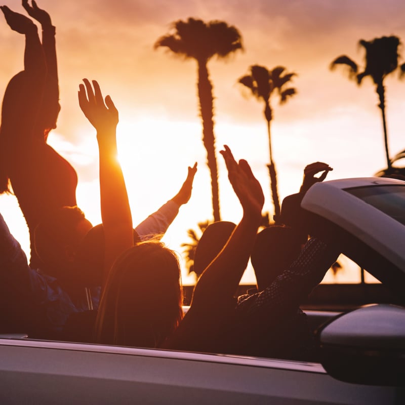 Group of friends on coastal road trip