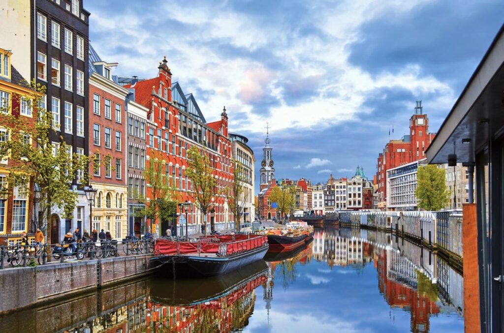 Canal in the Netherlands with colorful housing lining the canal. 