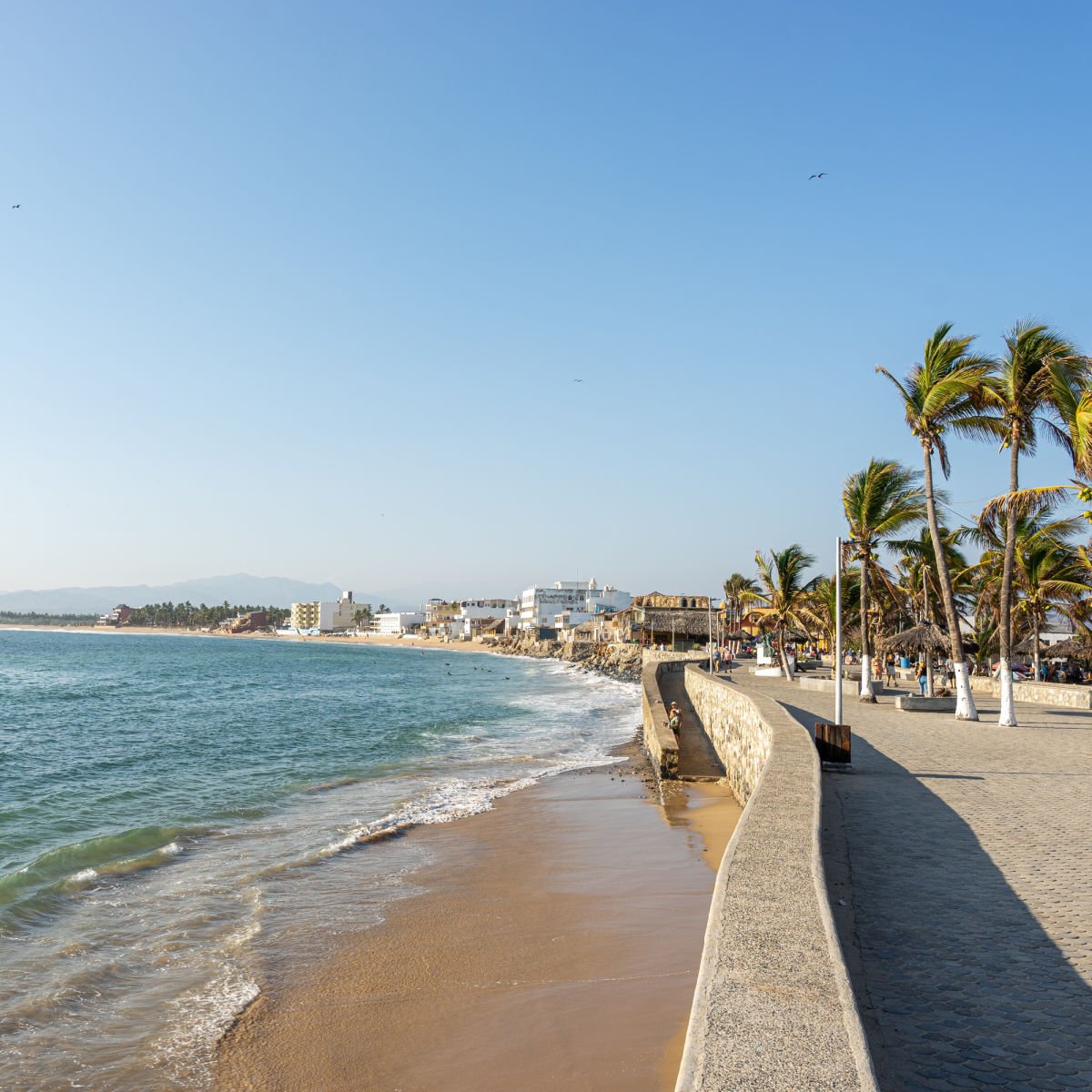 Promenade along blue waters of small Costalegre town